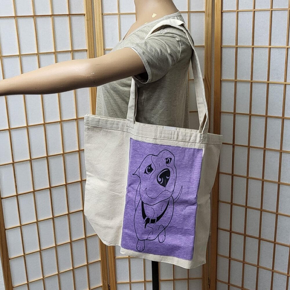 Large beige canvas tote bag with adorable puppy on purple fabric on the side EUC